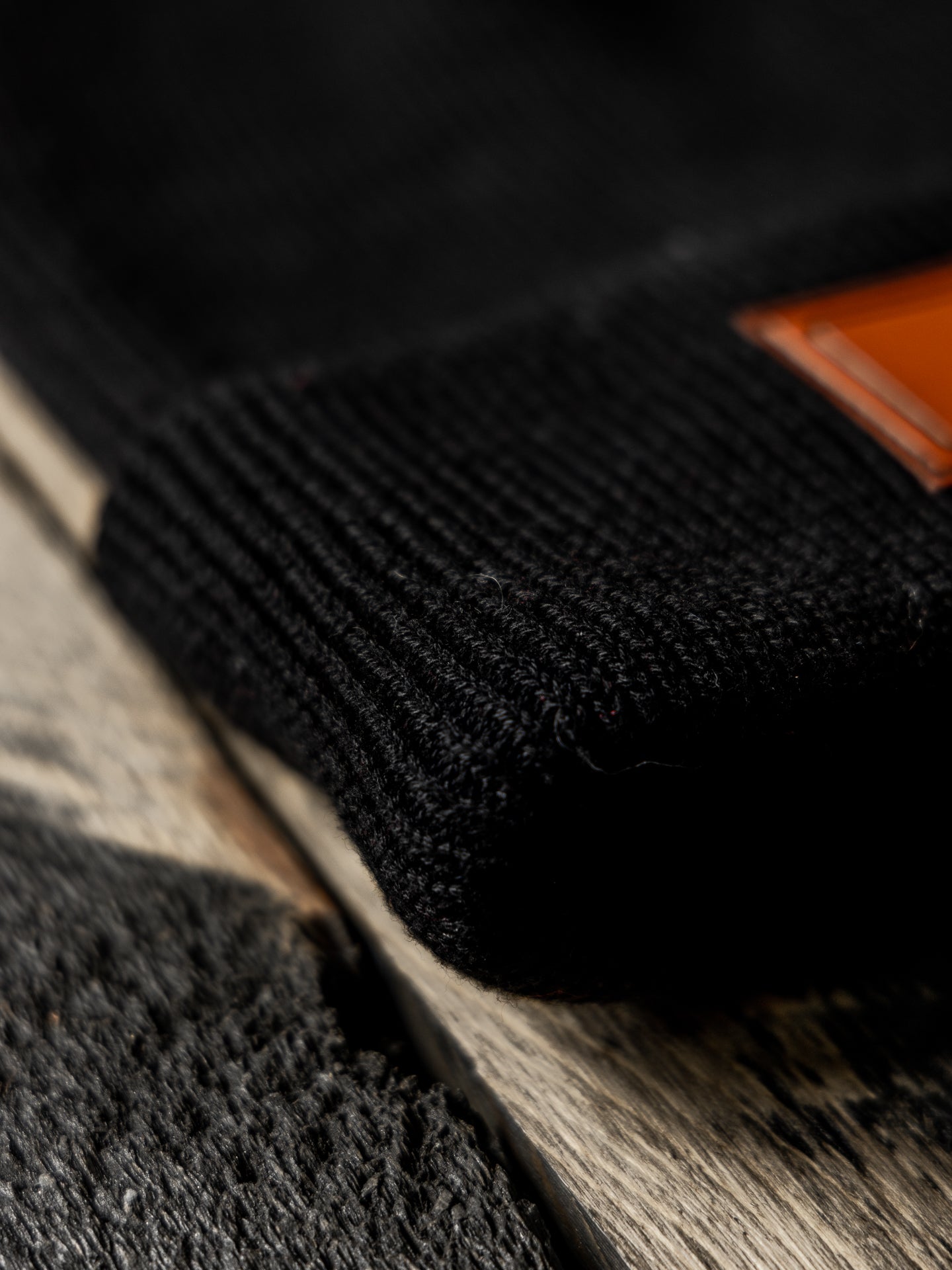 Black Beanie Hat Close-Up with Leather Patch