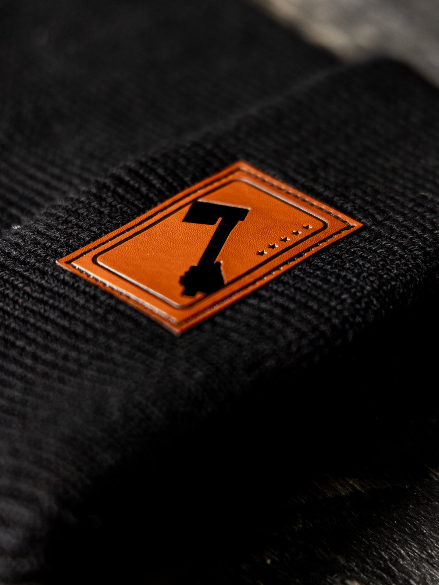 Black Beanie Hat Close-Up with Leather Patch